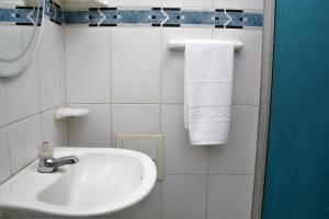 a white toilet sitting next to a sink in a bathroom at Hotel Stil Cartagena in Cartagena de Indias