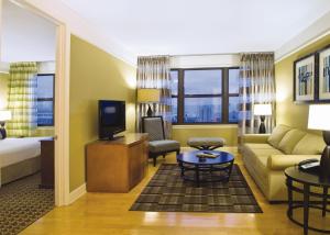 a living room filled with furniture and a tv at Club Wyndham Skyline Tower in Atlantic City