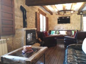 a living room with a fireplace and a couch at Los Colmenares in Cuzcurrita-Río Tirón