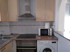 a kitchen with a microwave oven and a dishwasher at Mediterranean Bliss 317 in Cala de Finestrat