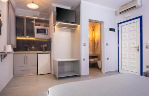 a small kitchen with a sink and a microwave at House Katerina Mediterranean in Sarti