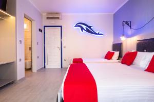 a bedroom with a bed with a red blanket on it at House Katerina Mediterranean in Sarti