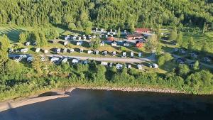 an aerial view of a parking lot next to a lake at Langnes Camping, Grong in Grong