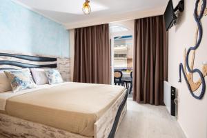a bedroom with a bed and a dining room at House Katerina Mediterranean in Sarti