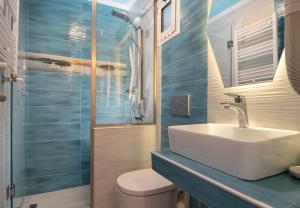 a bathroom with a sink and a toilet and a shower at House Katerina Mediterranean in Sarti