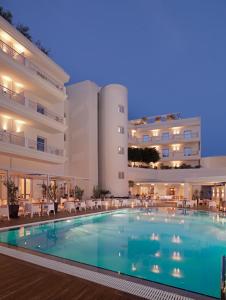 a swimming pool in the middle of a hotel at Elefsina Hotel in Eleusis