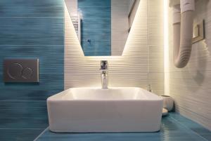 a bathroom with a white sink and a mirror at House Katerina Mediterranean in Sarti