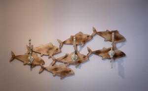 a group of brown birds hanging on a wall at House Katerina Mediterranean in Sarti