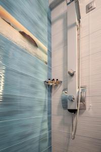 a bathroom with a shower with a glass door at House Katerina Mediterranean in Sarti