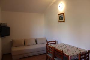 a living room with a couch and a table at Apartments Ante - 50m from the sea in Posedarje