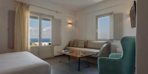 
a living room filled with furniture and a window at Elitoz Suites in Oia
