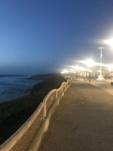 a wall with a view of the ocean at night at Casa Praia do Sul in Ericeira
