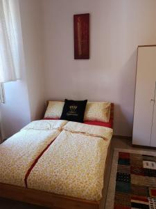 a bedroom with a bed with a pillow on it at Lilian City Center Studio in Graz