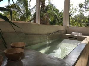 a jacuzzi tub in a room with a window at La Flor Casa Boutique in Valladolid
