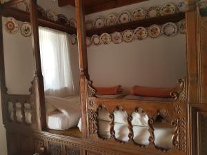 an ornate mirror in a room with a bed at Irene's House in Olympos