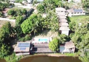 an aerial view of a house with a swimming pool at Pousada Lagoa da Mata in Guarapari