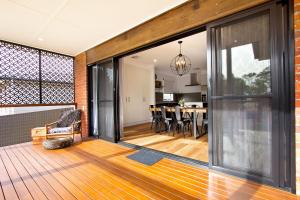 an open living room and dining room with sliding glass doors at The Clyde Greenock in Greenock