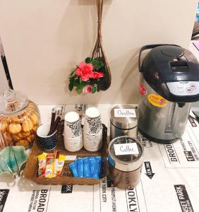 a table with a coffee maker and some food at Chiangmun Boutique in Chiang Mai