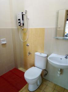 a bathroom with a toilet and a sink at Muslim 2 Stay in Melaka