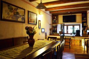 a dining room with a table with a vase of flowers on it at La Giara Bed&Breakfast in Brienza