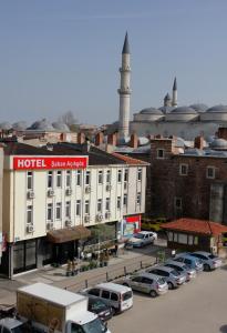 a large hotel with cars parked in a parking lot at Saban Acikgoz Hotel in Edirne