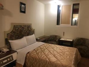 Ein Bett oder Betten in einem Zimmer der Unterkunft 真正好旅店 Good Hotel