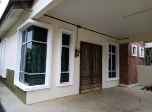 a front door of a house with windows at Muslim 2 Stay in Melaka