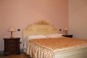 Postel nebo postele na pokoji v ubytování Agriturismo I Chiosi