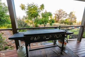 a grill on a porch with a table on a deck at Bulwarra Bed & Breakfast in Dubbo