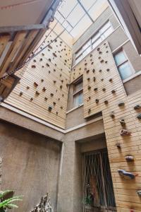 a building with a climbing wall on the side of it at Bao Cheng Home in Tainan +42 photos