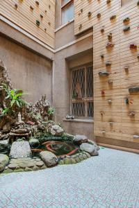 a building with a rock wall with a turtle on it at Bao Cheng Home in Tainan