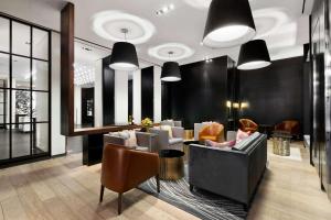 
a living room filled with furniture and a large window at Andaz 5th Avenue-a concept by Hyatt in New York
