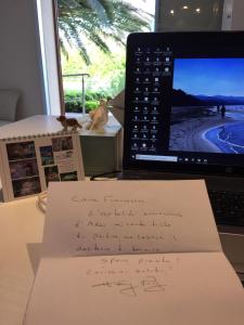 a laptop computer sitting on a desk with a handwritten note at Arli Hotel Hideaway Punta Ala - Adults Only in Punta Ala