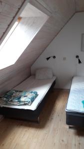 a bedroom with two beds in a attic at Törnholmen in Garnanäs