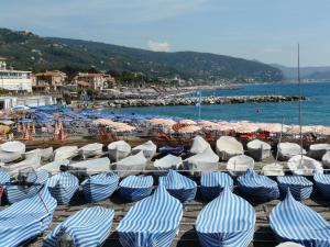 a group of blue and white umbrellas on a beach at Hotel Bristol in Lavagna