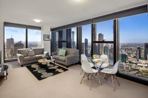 a living room with a view of a city at Winston Apartments in Melbourne