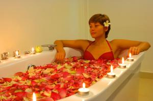 a woman in a bikini sitting in a bath tub at Pigeon Island Beach Resort in Nilaveli
