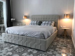 a bedroom with a large bed with two pillows at Lee House in Sliema