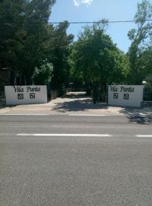 two signs on the side of a road at Vila Punta in Šibuljina