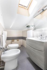 a bathroom with a white toilet and a sink at B&B Porta delle Madonie in Campofelice di Roccella