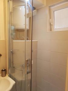 a shower with a glass door in a bathroom at Sarajevo, Stari Grad, Apartment in Sarajevo +70 photos