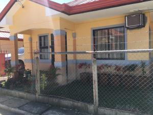 a fence in front of a house at Jireh’s Guests Home in Butuan