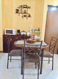 a dining room table and chairs in a kitchen at Jireh’s Guests Home in Butuan