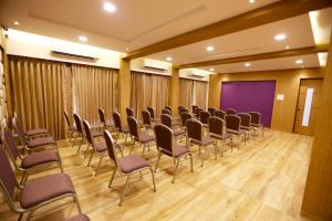 a conference room with chairs and a purple screen at Silverador Boutique Hotel in Thane