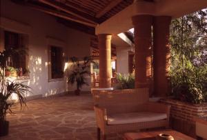 a porch with a couch and chairs on a house at A Giummara in Marsala