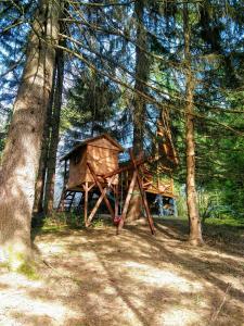 a tree house in the middle of a forest at Ski Lake Cottage Krpáčovo in Krpacovo