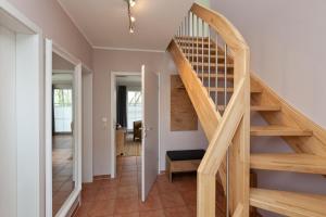 a wooden staircase in a home with a hallway at Ferienhaus Buche im Land Fleesensee in Göhren-Lebbin