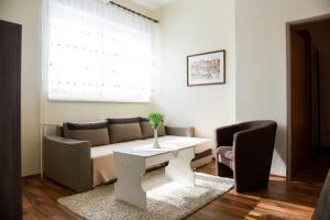 a living room with a couch and a table at Hotel Rubín in Svidník