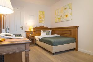 a bedroom with a bed and a desk with a phone at Landhaus Lellichow in Lellichow