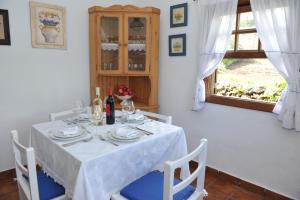 a dining room with a table with a white table cloth at Casa Rural Claudio in Mazo
